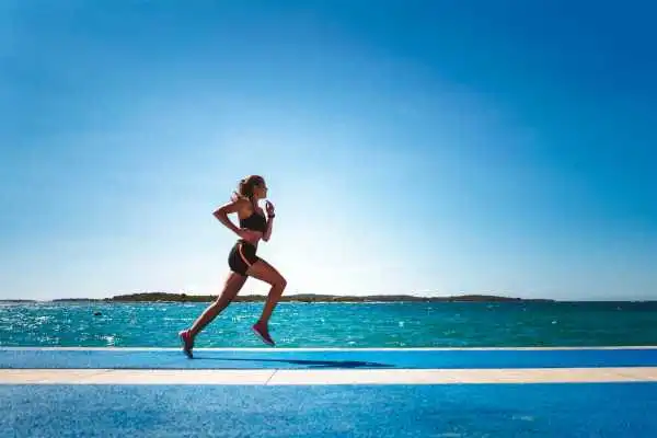 Woman running showing strong leg muscle Stevenage Ware